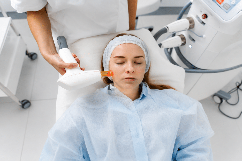 Woman undergoes cosmetic laser treatment in a comfortable, professional setting.