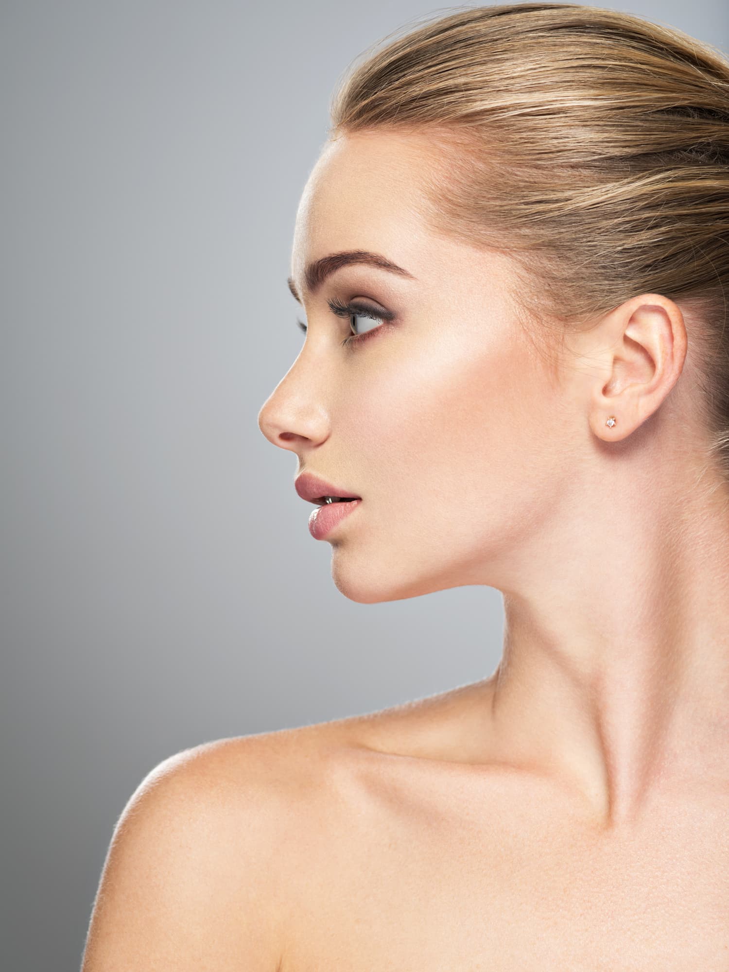 Profile view of a woman with smooth skin and defined facial contours after Restylane treatment.